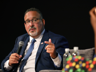 A conversation with US Secretary of Education Miguel Cardona (left) and Errin Haines (right) (cq) at the Forum Theater in the Birmingham-Jefferson Convention Complex in Birmingham, Alabama. (Photo by Edi H. Doh / NABJ MONITOR)