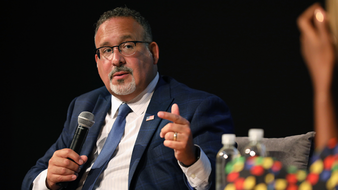 A conversation with US Secretary of Education Miguel Cardona (left) and Errin Haines (right) (cq) at the Forum Theater in the Birmingham-Jefferson Convention Complex in Birmingham, Alabama. (Photo by Edi H. Doh / NABJ MONITOR)