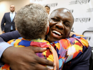 Ken Lemon embraces a supporter after being elected as the 23rd president of NABJ. (Photo by Edi H. Doh)