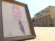 Framed photo of Dr. Jesse Lewis outside of the Birmingham Times headquarters on Aug. 1, 2023