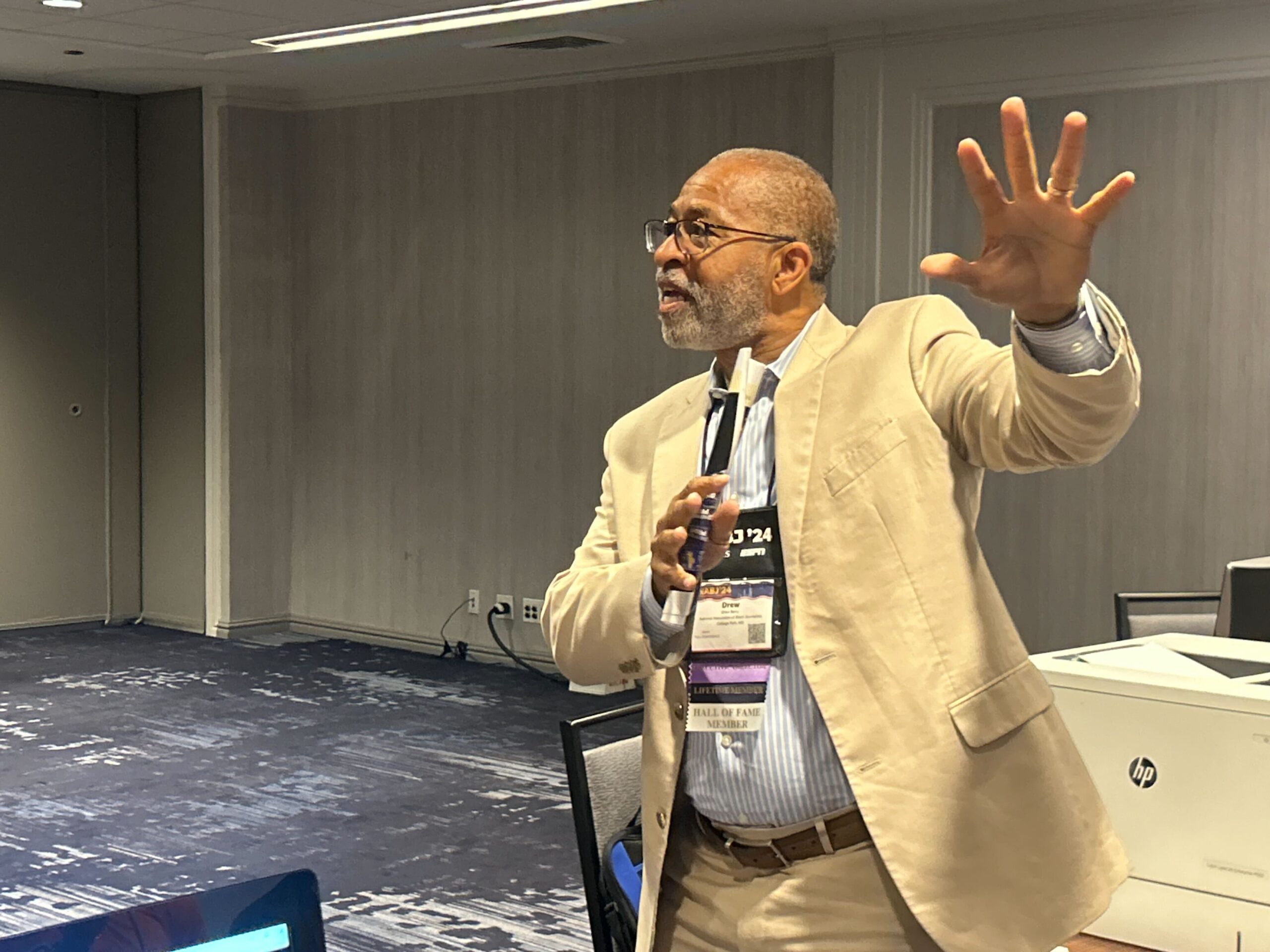 NABJ Executive Director Drew Berry speaks to the NABJ Multimedia Student Projects newsroom about former President Donald Trump's panel.