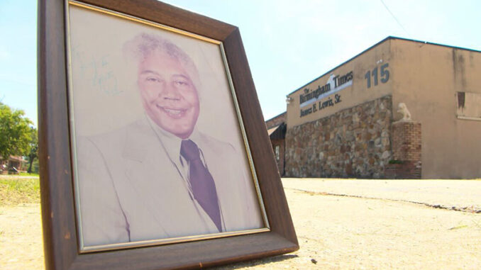 Framed photo of Dr. Jesse Lewis outside of the Birmingham Times headquarters on Aug. 1, 2023
